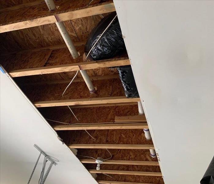 cut out ceiling showing studs with no insulation 