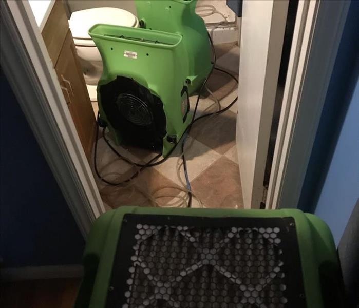 Wet materials removed, cleaned and dry equipment set 2 green air movers and green dehumidifier.