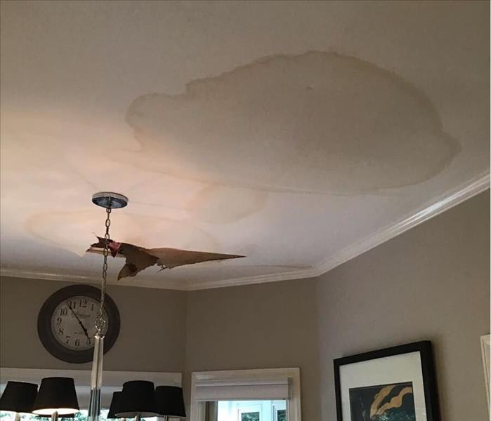 Kitchen Ceiling showing visible staining from busted pipe in kitchen ceiling.  Drywall collapsing from kitchen ceiling.