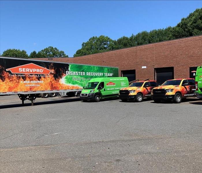 Servpro Disaster Revovery team trailer, 2 fire and water pickup trucks and 2 green van promasters. 